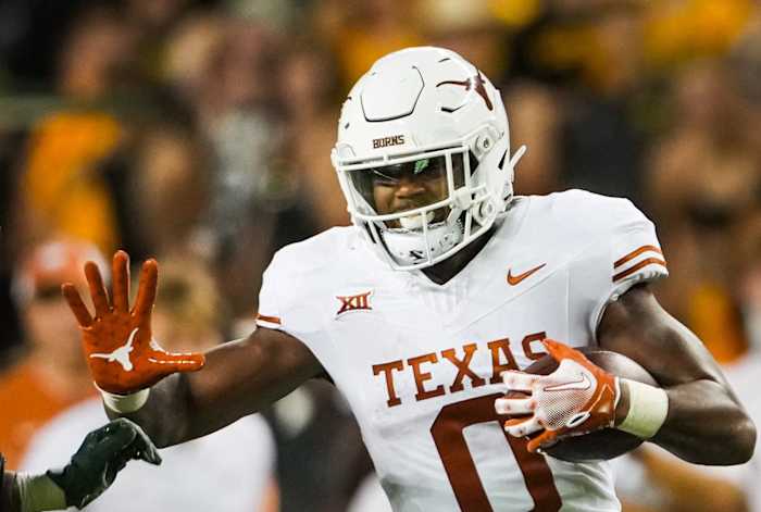 Texas tight end Ja'Tavion Sanders (0) carries the ball as Baylor safety Devin Lemear (20) chases during the third quarter of the Longhorns' game against the Baylor Bears